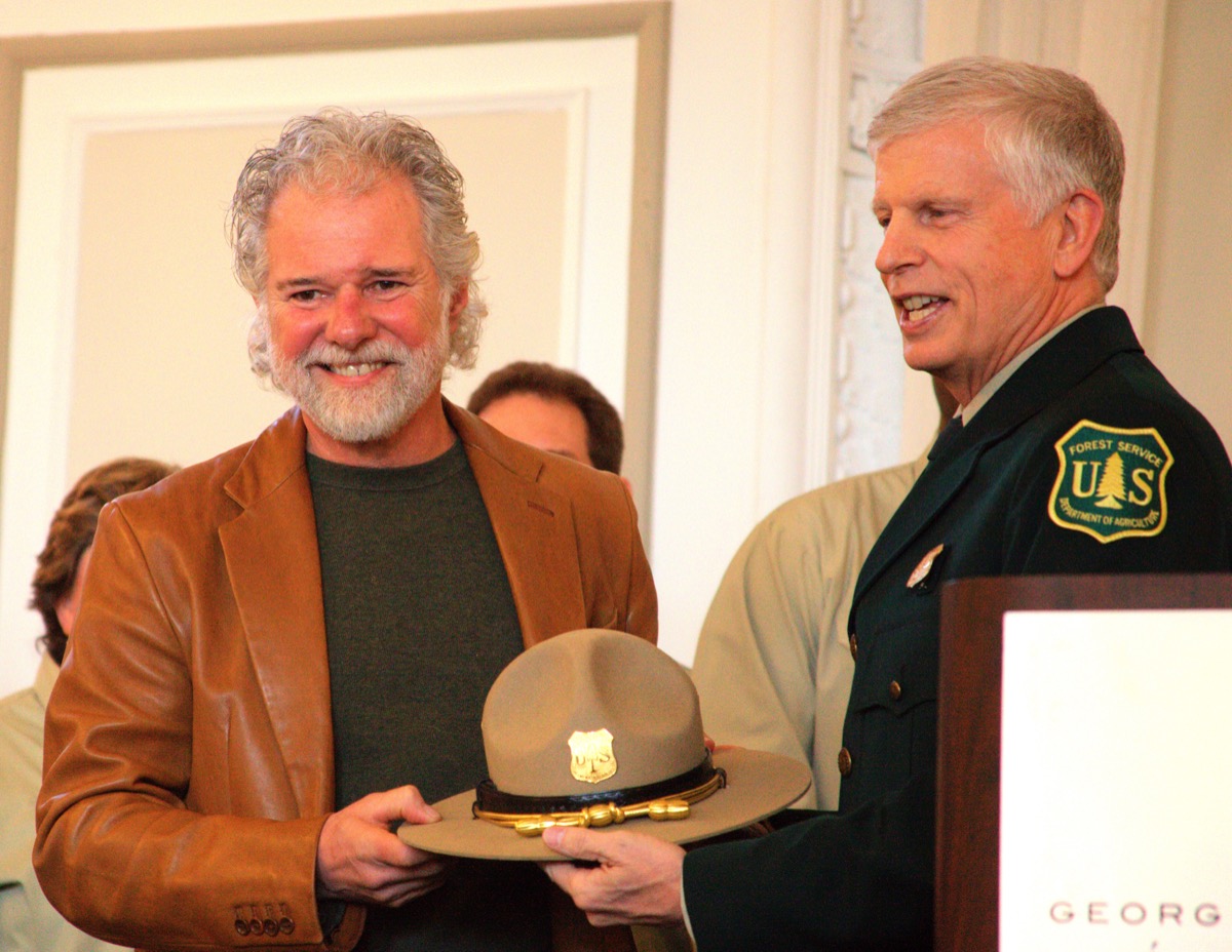 Chuck Leavell accepts a Forest Service ranger hat from Forest Service Chief Tom Tidwell at a ceremony in Atlanta, Georgia, in February 2012