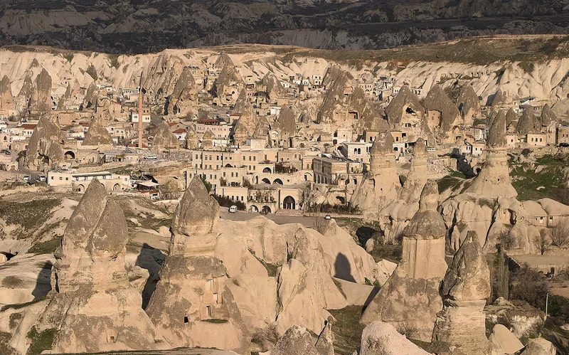 Cappadocia landscape with fairy chimney rock formations and buildings