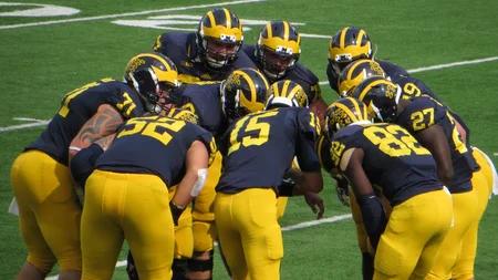 The football huddle is credited to one deaf quarterback hiding his hands. In 1894, Gallaudet played 