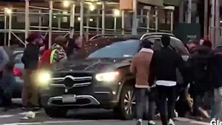 A 25-year-old woman was pinned face-down under a Mercedes-Benz at a Manhattan intersection. The rear