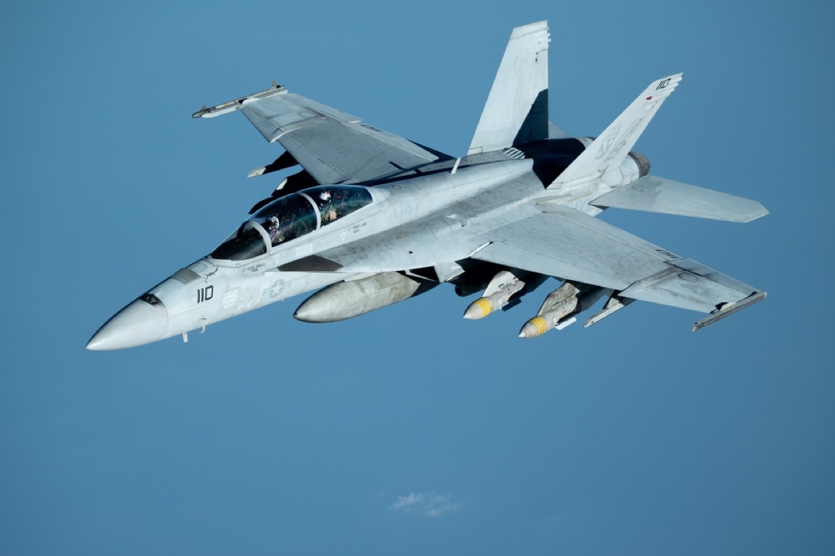 A US Navy F/A-18 Super Hornet fighter jet in flight against a blue sky, the same type of aircraft flown by the pilots who recorded the GIMBAL and GoFast footage