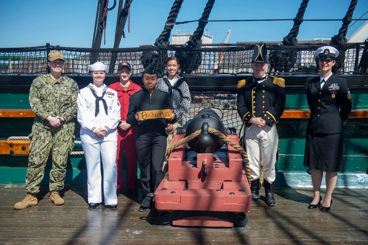 Active-duty US Navy sailors in dress uniform standing on the deck of USS Constitution, Charlestown Navy Yard, Boston