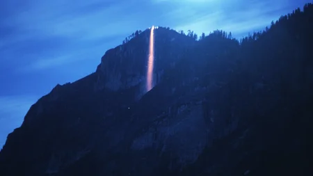 Yosemite ran a real fire waterfall for nearly a century. On summer nights, workers built a bonfire o